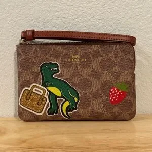 COACH corner zip signature wristlet dinosaur T-rex
